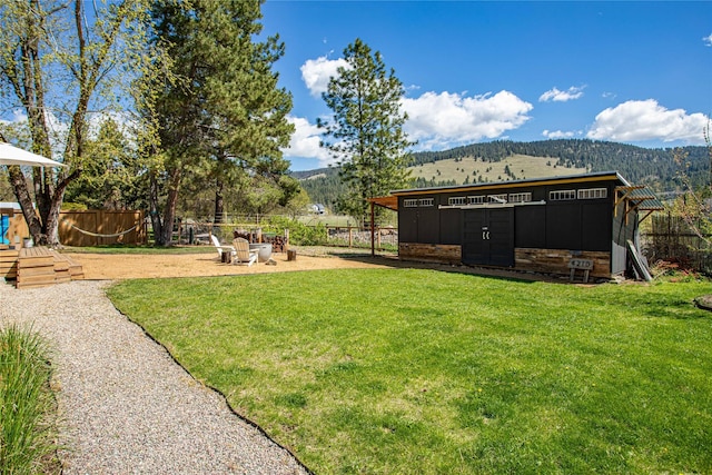 4210 Lincoln Rd, Missoula, MT 59802 - view of yard featuring an outbuilding, a mountain view, and fence
