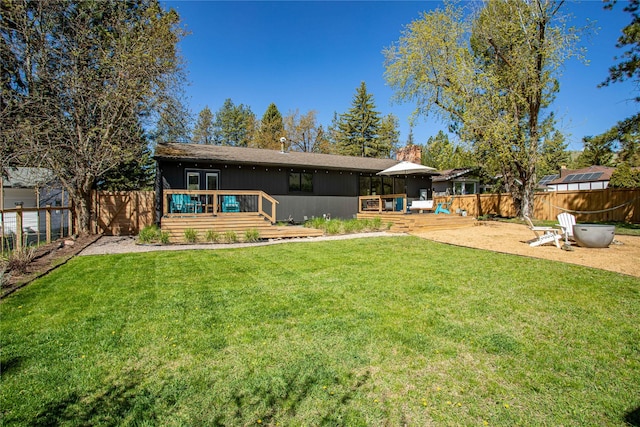 4210 Lincoln Rd, Missoula, MT 59802 - rear view of house featuring a fenced backyard, a deck, and a yard