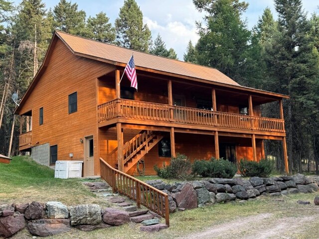 1180 Grandview Dr, Seeley Lake, MT 59868 - view of front of house featuring a deck and stairs