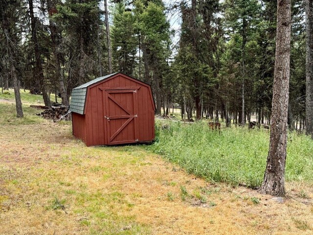 1180 Grandview Dr, Seeley Lake, MT 59868 - view of shed with a forest view