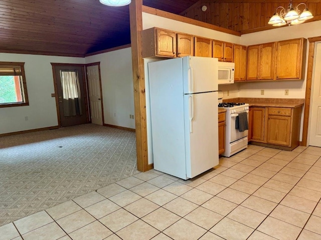 1180 Grandview Dr, Seeley Lake, MT 59868 - kitchen with white appliances, wood ceiling, lofted ceiling, hanging light fixtures, and brown cabinets