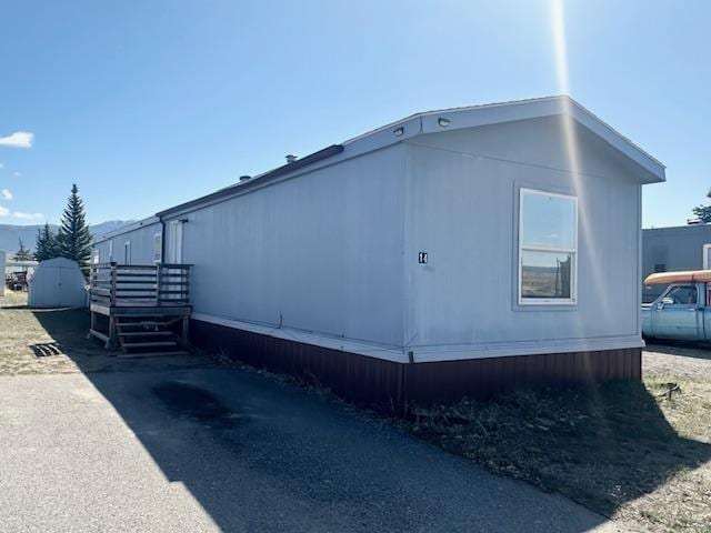 view of home's exterior featuring an outdoor structure and a storage unit