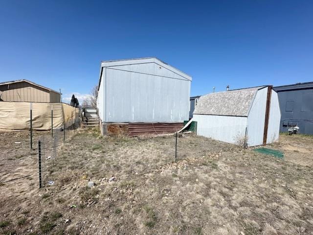 view of shed featuring fence
