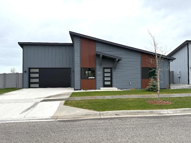 3433 Goldenrod Ln, Kalispell, MT 59901 - contemporary home featuring fence, an attached garage, and driveway