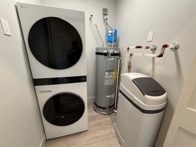 3431 Goldenrod Ln, Kalispell, MT 59901 - washroom featuring laundry area, stacked washer and clothes dryer, baseboards, light wood-type flooring, and electric water heater