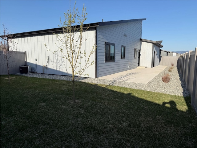 3431 Goldenrod Ln, Kalispell, MT 59901 - back of house with a yard, cooling unit, a fenced backyard, and a patio area