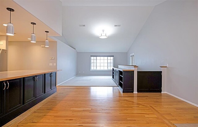 4891 Christian Dr, Missoula, MT 59803 - kitchen featuring under cabinet range hood, stove, light wood finished floors, and stainless steel fridge