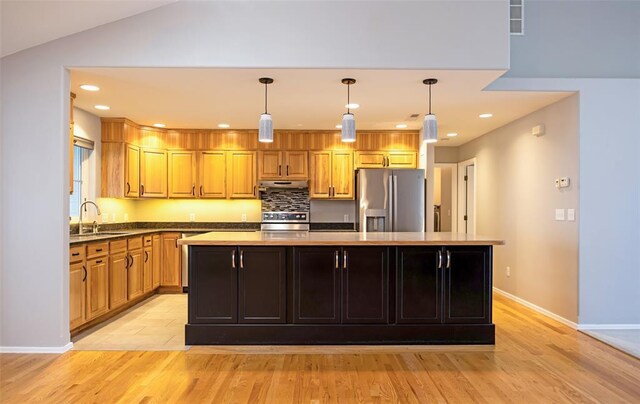 4891 Christian Dr, Missoula, MT 59803 - kitchen with lofted ceiling, visible vents, light wood-style floors, and hanging light fixtures