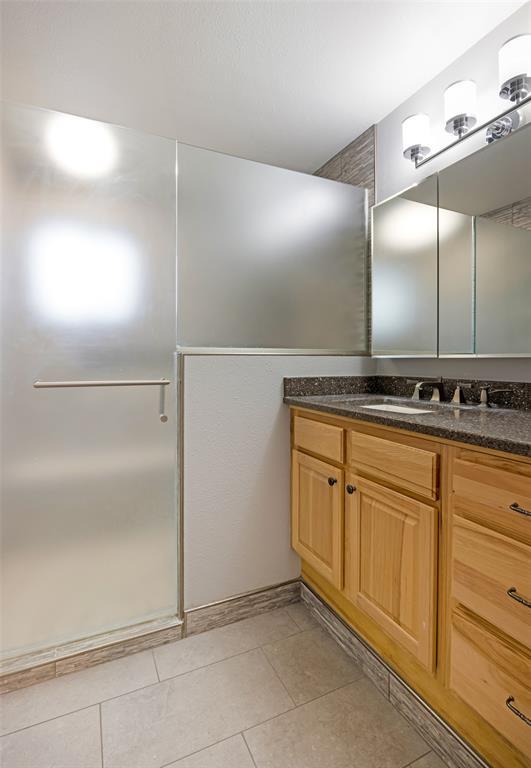 4891 Christian Dr, Missoula, MT 59803 - laundry room with baseboards, light tile patterned flooring, independent washer and dryer, and cabinet space