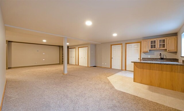 4891 Christian Dr, Missoula, MT 59803 - kitchen with dark countertops, a breakfast bar area, glass insert cabinets, baseboards, and a peninsula
