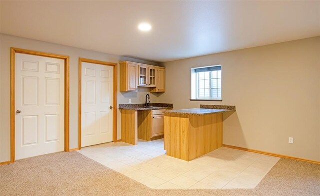 4891 Christian Dr, Missoula, MT 59803 - kitchen featuring a peninsula, a healthy amount of sunlight, a sink, and glass insert cabinets