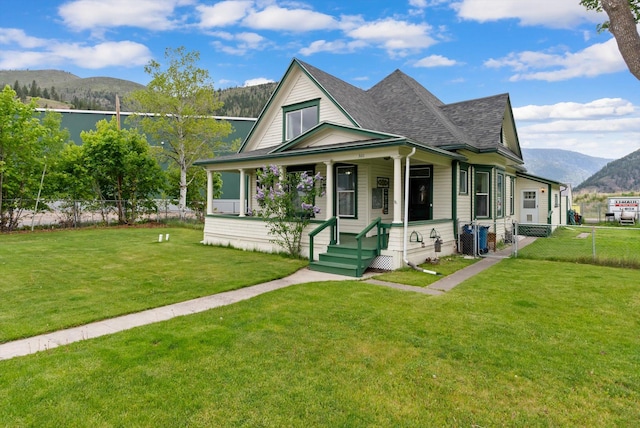 360 White House Ln, Bonner, MT 59823 - view of front of house featuring a mountain view, roof with shingles, and covered porch