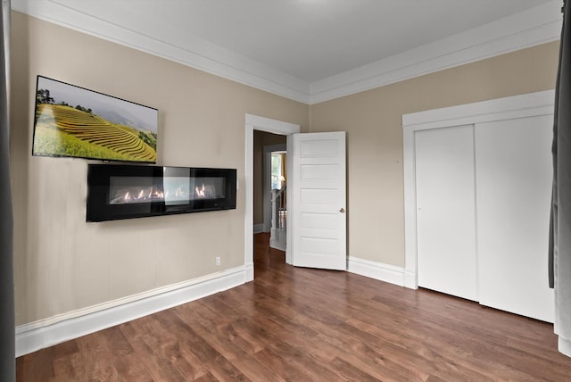 360 White House Ln, Bonner, MT 59823 - unfurnished bedroom featuring wood finished floors, baseboards, crown molding, and a closet