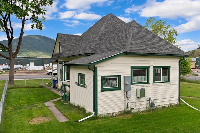 360 White House Ln, Bonner, MT 59823 - view of side of property with a yard, roof with shingles, and a mountain view