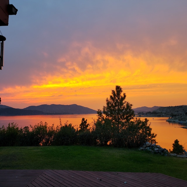 deck featuring a yard and a water and mountain view