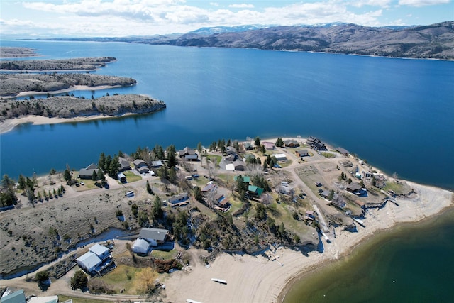 drone / aerial view with a water and mountain view
