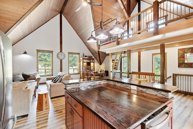 kitchen featuring open floor plan, a ceiling fan, light wood-style flooring, and plenty of natural light