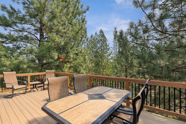 wooden deck featuring outdoor dining space