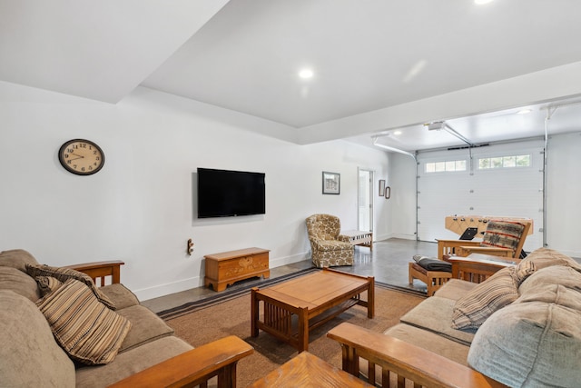living area with finished concrete flooring, baseboards, and recessed lighting
