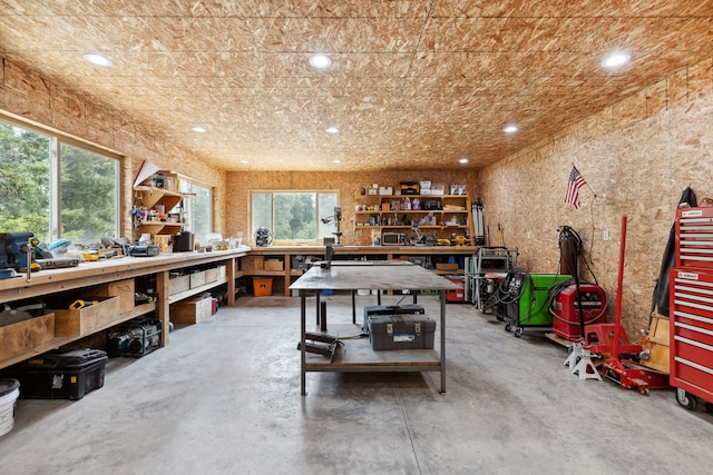 interior space featuring concrete floors, a workshop area, and recessed lighting
