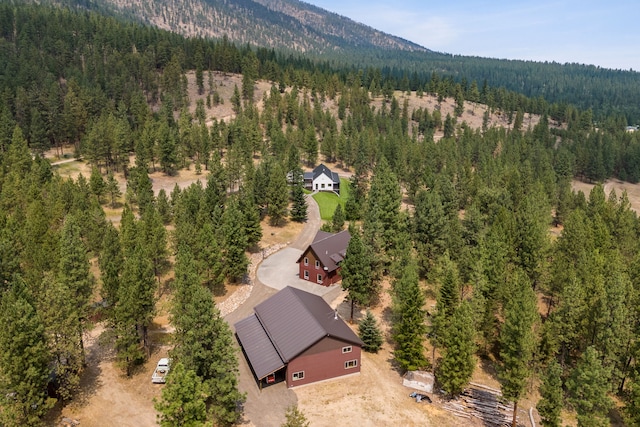 aerial view featuring a forest view and a mountain view