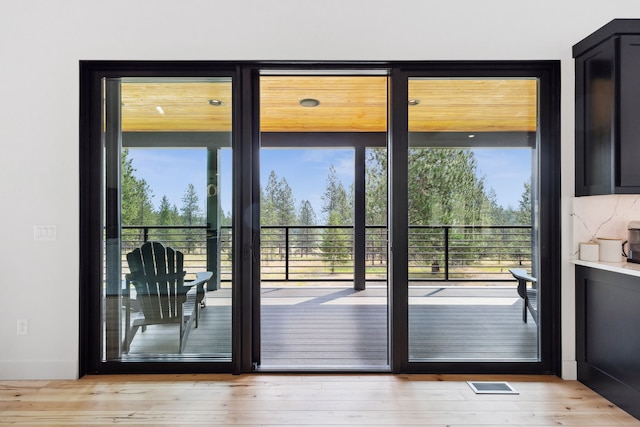 entryway with wood finished floors and visible vents