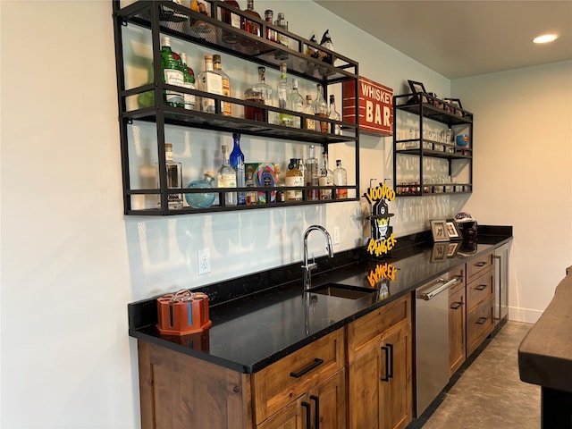bar with stainless steel dishwasher, a sink, wet bar, recessed lighting, and concrete flooring