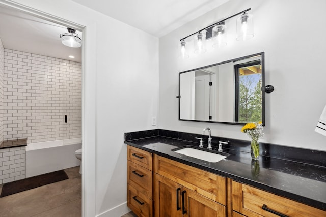 bathroom featuring vanity, washtub / shower combination, and toilet