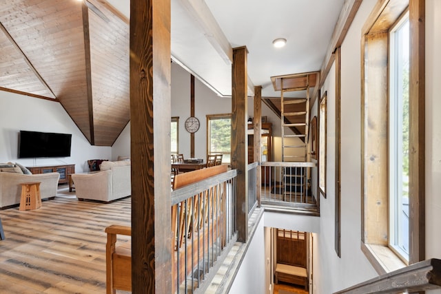stairs with wood finished floors and lofted ceiling