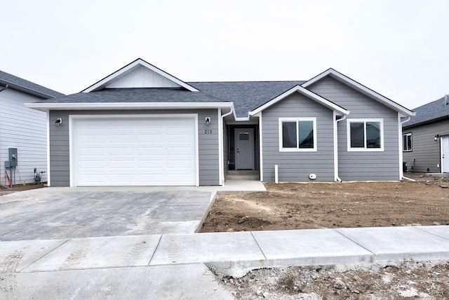 215 Meadow View Loop, East Helena, MT 59635 - ranch-style house featuring an attached garage, driveway, roof with shingles, and board and batten siding