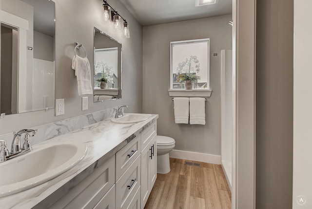 215 Meadow View Loop, East Helena, MT 59635 - full bathroom with toilet, wood finished floors, a sink, and visible vents