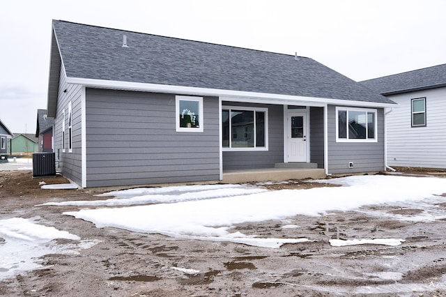 215 Meadow View Loop, East Helena, MT 59635 - snow covered house featuring roof with shingles and central AC unit