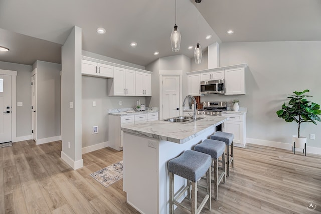 215 Meadow View Loop, East Helena, MT 59635 - kitchen featuring white cabinets, vaulted ceiling, appliances with stainless steel finishes, and a sink