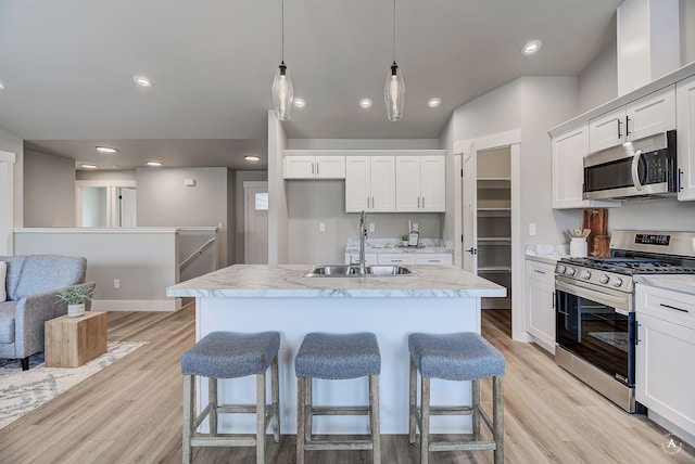 215 Meadow View Loop, East Helena, MT 59635 - kitchen with appliances with stainless steel finishes, a kitchen breakfast bar, white cabinetry, and a sink