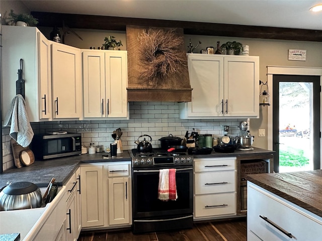 11 High Country Ct, Plains, MT 59859 - kitchen featuring dark countertops, dark wood-style flooring, stainless steel microwave, and gas range oven