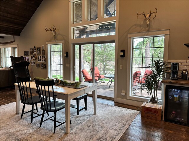 11 High Country Ct, Plains, MT 59859 - dining area with beverage cooler, wood ceiling, hardwood / wood-style flooring, baseboards, and high vaulted ceiling