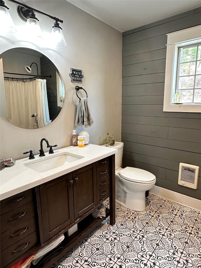 11 High Country Ct, Plains, MT 59859 - full bathroom with vanity, heating unit, toilet, wood walls, and tile patterned flooring