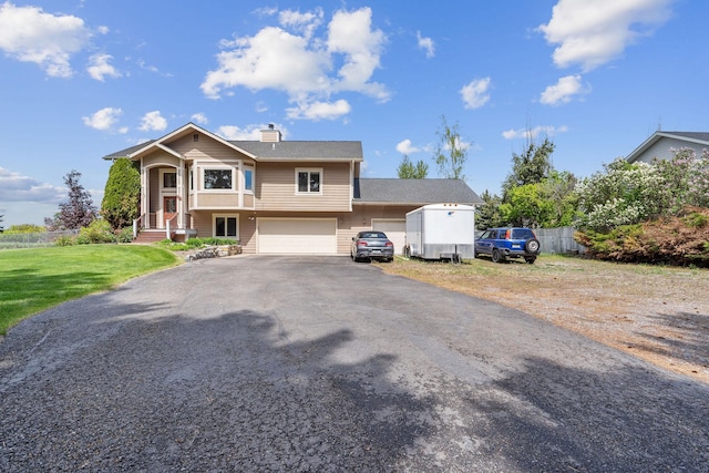 515 Country Way, Kalispell, MT 59901 - view of front of property featuring asphalt driveway, a chimney, and an attached garage