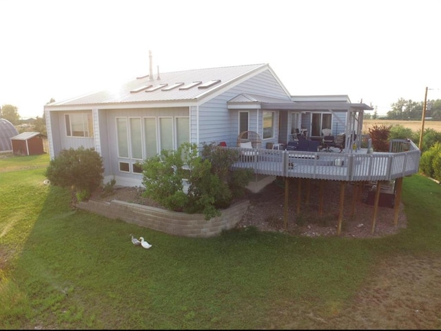 652 Simms Ashuelot Rd, Fort Shaw, MT 59443 - rear view of house featuring a lawn, a deck, and metal roof