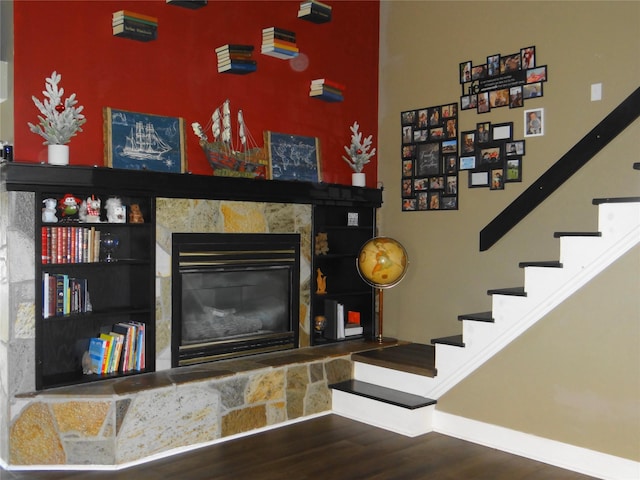 652 Simms Ashuelot Rd, Fort Shaw, MT 59443 - living room with a stone fireplace, baseboards, stairs, and wood finished floors