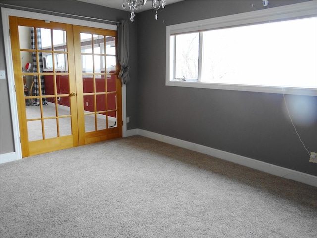 652 Simms Ashuelot Rd, Fort Shaw, MT 59443 - carpeted empty room featuring baseboards, a chandelier, and french doors
