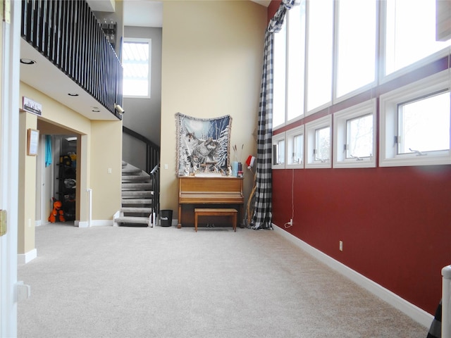 652 Simms Ashuelot Rd, Fort Shaw, MT 59443 - interior space featuring baseboards, stairs, carpet, and a high ceiling