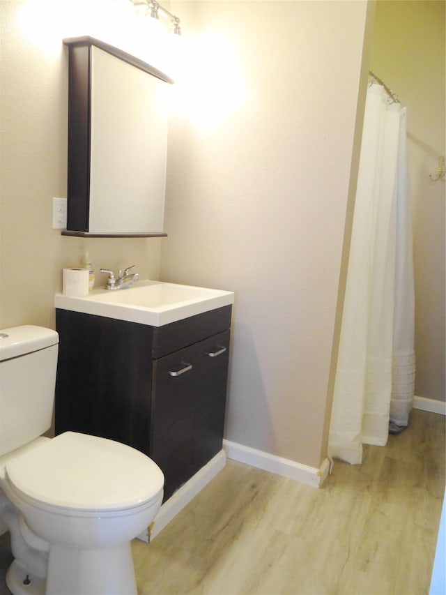 652 Simms Ashuelot Rd, Fort Shaw, MT 59443 - bathroom featuring vanity, baseboards, wood finished floors, and toilet