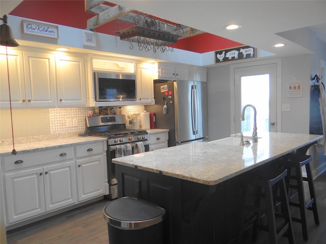652 Simms Ashuelot Rd, Fort Shaw, MT 59443 - kitchen with decorative backsplash, light stone countertops, white cabinetry, a sink, and appliances with stainless steel finishes