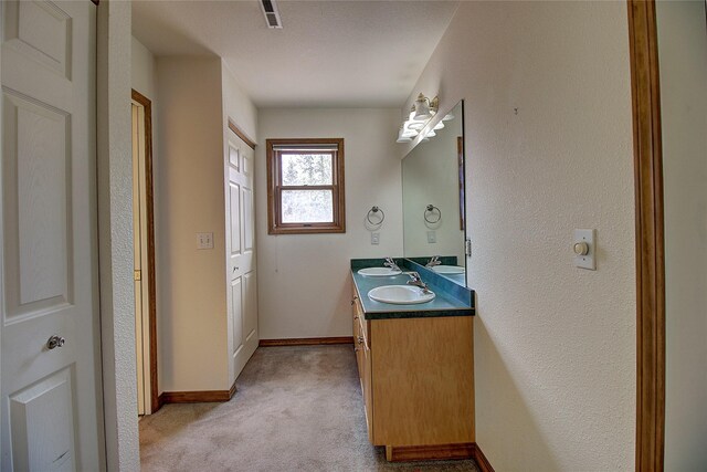 full bath with visible vents, a sink, and double vanity
