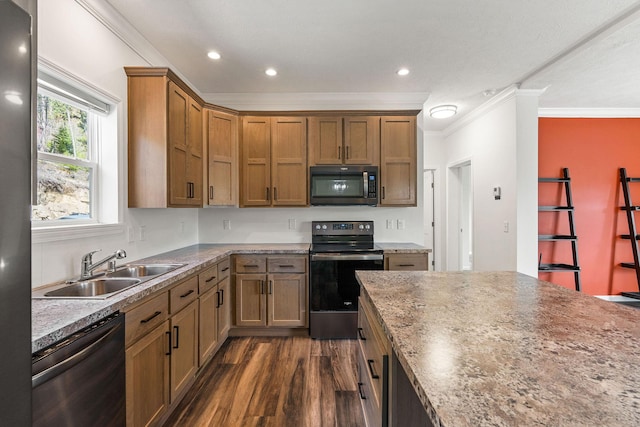kitchen featuring brown cabinets, dark wood-style floors, stainless steel appliances, a sink, and crown molding