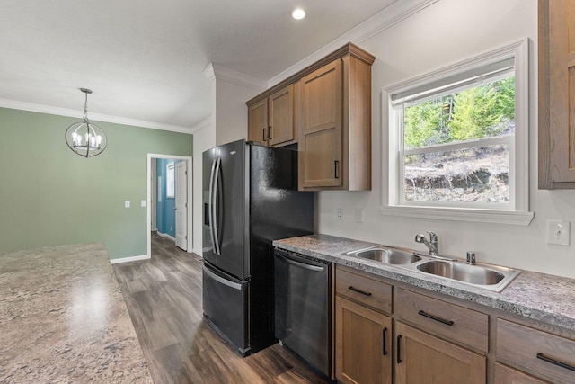 kitchen with a sink, ornamental molding, appliances with stainless steel finishes, a notable chandelier, and dark wood-style floors
