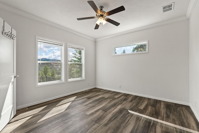 empty room with baseboards, wood finished floors, visible vents, and ornamental molding