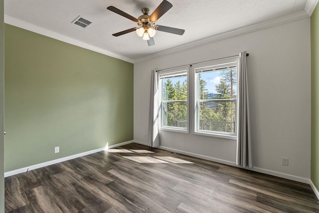 unfurnished room with dark wood finished floors, ornamental molding, and visible vents
