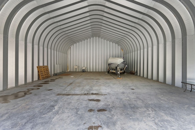 misc room featuring a garage and lofted ceiling